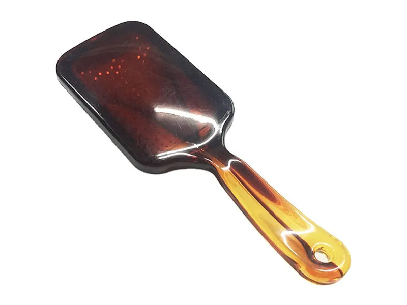 Escova de cabelo de cor âmbar com pinos de metal