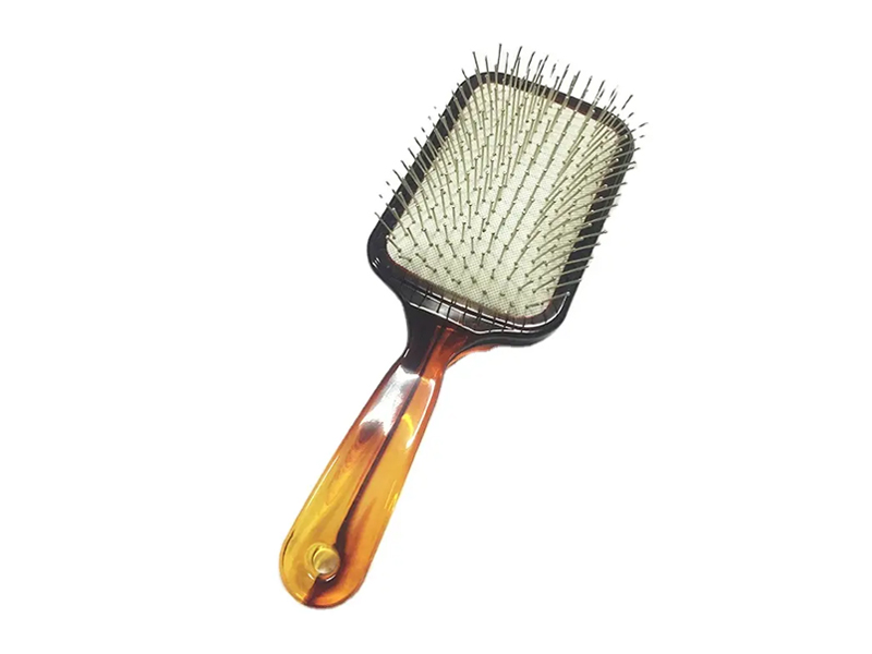 Escova de cabelo de cor âmbar com pinos de metal